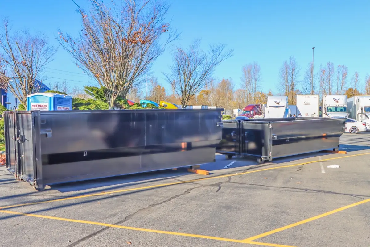 Professional dumpster rental service with roll-off container on residential driveway in Gold River